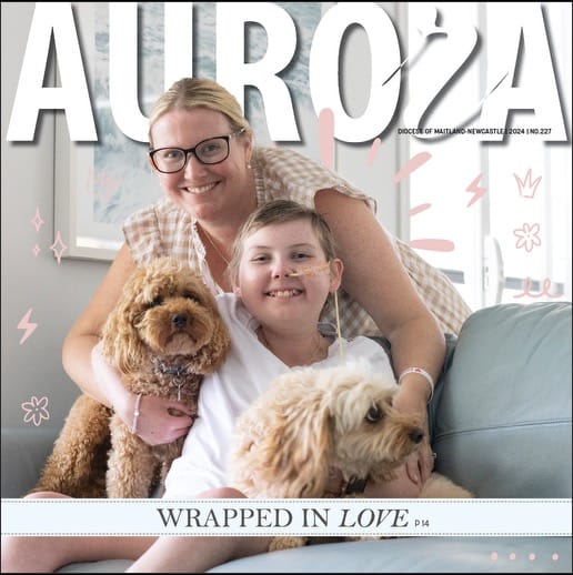 The front cover of Aurora Magazine - Emma and her Mum and two pet dogs sitting on a couch.